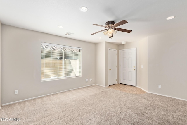 unfurnished room with light carpet, ceiling fan, baseboards, and recessed lighting