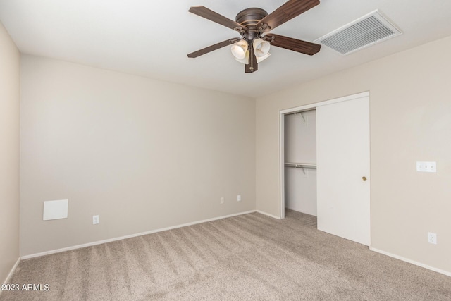 unfurnished bedroom with visible vents, baseboards, a closet, and carpet