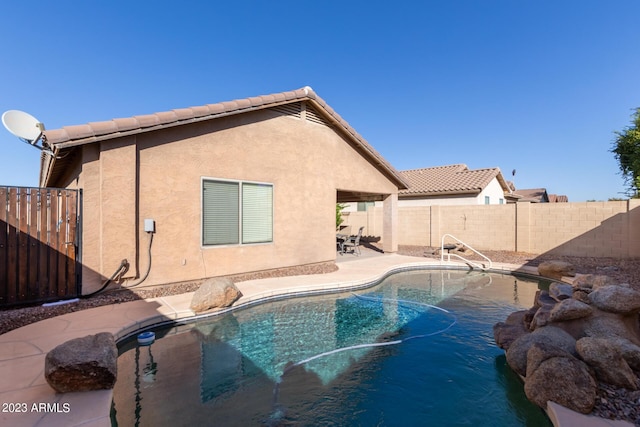 view of swimming pool with a fenced backyard, a fenced in pool, and a patio area