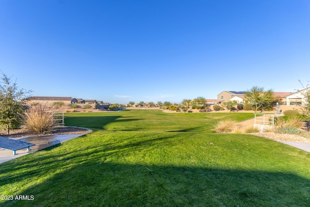 view of property's community featuring a residential view and a lawn
