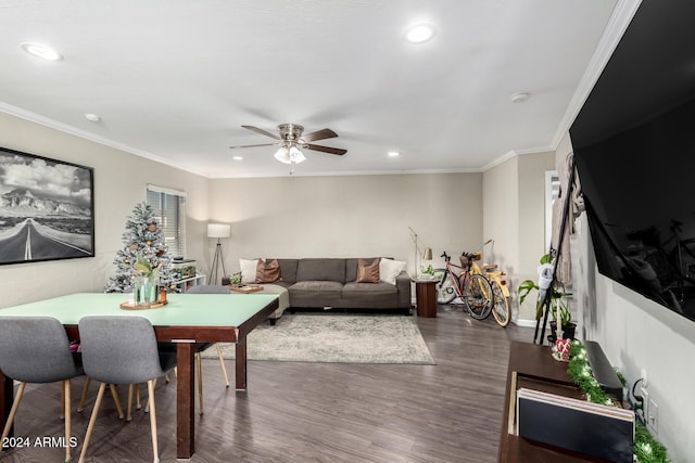 living room featuring dark hardwood / wood-style floors, ceiling fan, and ornamental molding