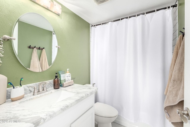 bathroom featuring curtained shower, vanity, and toilet