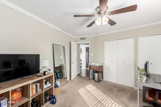 interior space featuring multiple closets, ceiling fan, light colored carpet, and ornamental molding