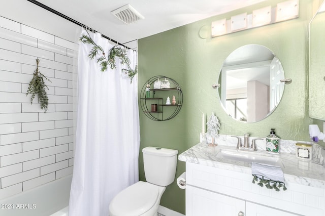 full bathroom with vanity, shower / tub combo, and toilet