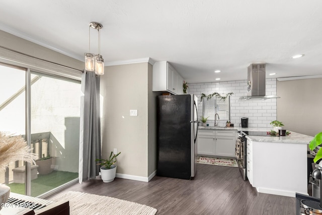 kitchen with dark hardwood / wood-style flooring, wall chimney exhaust hood, stainless steel appliances, decorative light fixtures, and white cabinetry