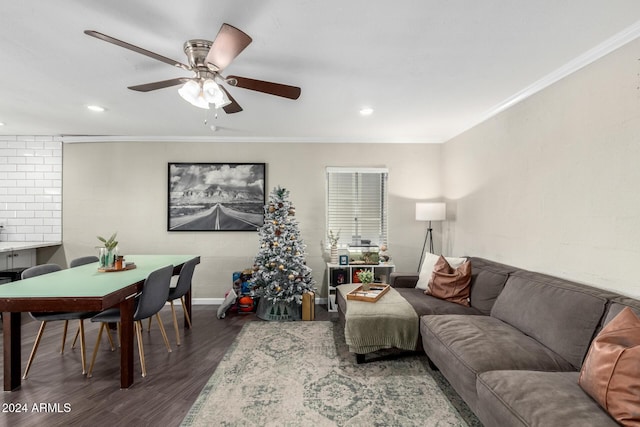 living room with dark hardwood / wood-style floors, ceiling fan, and ornamental molding