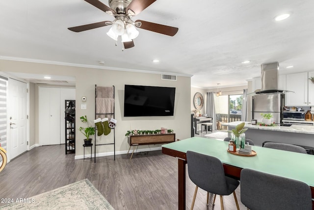 dining room featuring dark hardwood / wood-style floors, ceiling fan, and ornamental molding