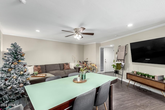 dining space with ceiling fan, crown molding, and dark wood-type flooring