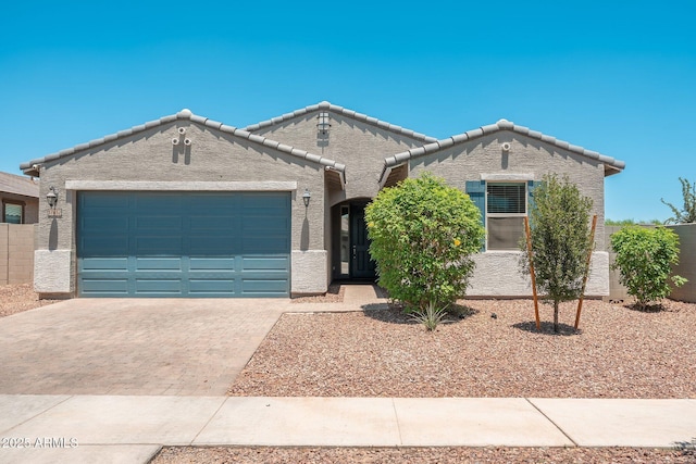 17652 W Fetlock Trl, Surprise, AZ 85387 - view of front of property featuring stucco siding, a garage, decorative driveway, and a tiled roof