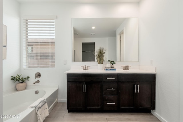 17652 W Fetlock Trl, Surprise, AZ 85387 - bathroom with double vanity, a bath, and wood finished floors