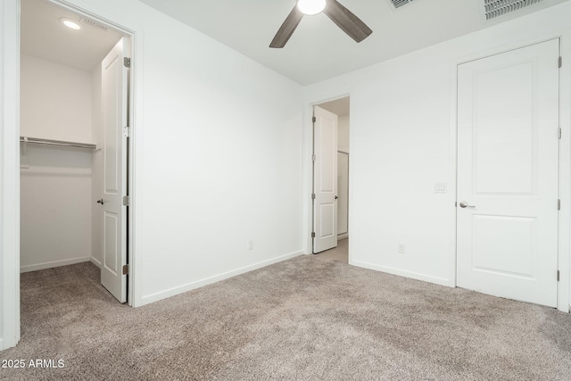 17652 W Fetlock Trl, Surprise, AZ 85387 - unfurnished bedroom featuring carpet, a walk in closet, a closet, and a ceiling fan