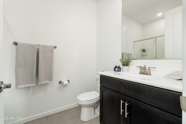 17652 W Fetlock Trl, Surprise, AZ 85387 - bathroom featuring vanity, an enclosed shower, and wood finish floors