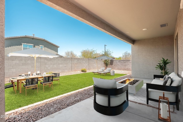 17652 W Fetlock Trl, Surprise, AZ 85387 - fenced backyard featuring a patio area, an outdoor living space with a fire pit, and outdoor dining area