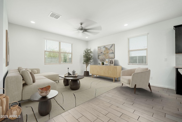 17652 W Fetlock Trl, Surprise, AZ 85387 - living room with recessed lighting, ceiling fan, and wood finished floors