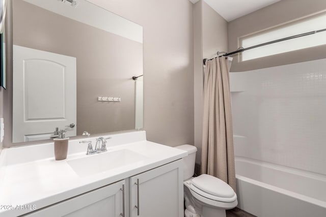 full bathroom with shower / bathtub combination with curtain, vanity, and toilet