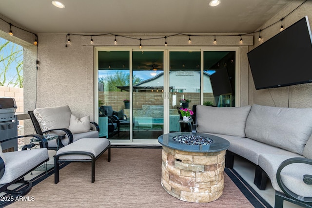 view of patio / terrace featuring an outdoor living space with a fire pit