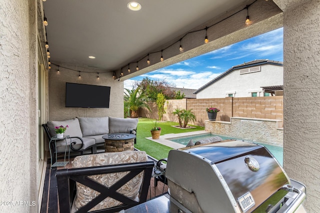 view of patio / terrace featuring area for grilling, a pool, and an outdoor living space with a fire pit