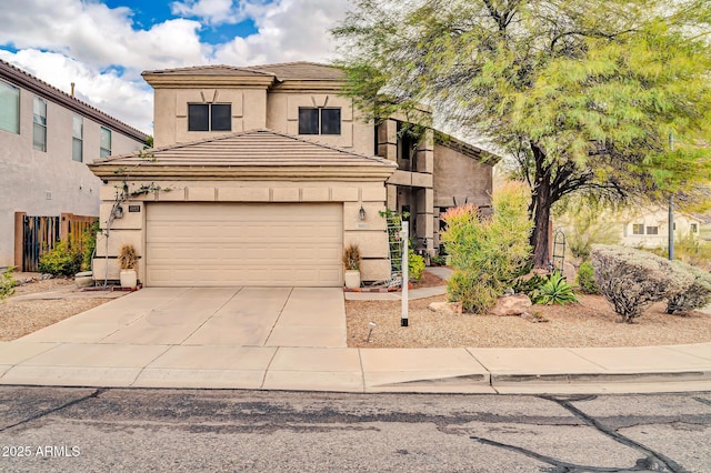 view of front of house with concrete driveway, a tiled roof, a garage, and stucco siding