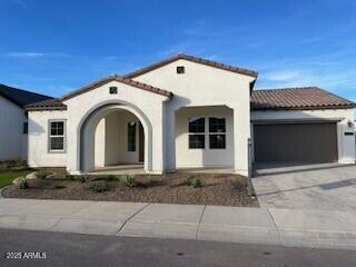 mediterranean / spanish-style home with a garage