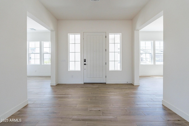 entryway featuring plenty of natural light and light hardwood / wood-style flooring