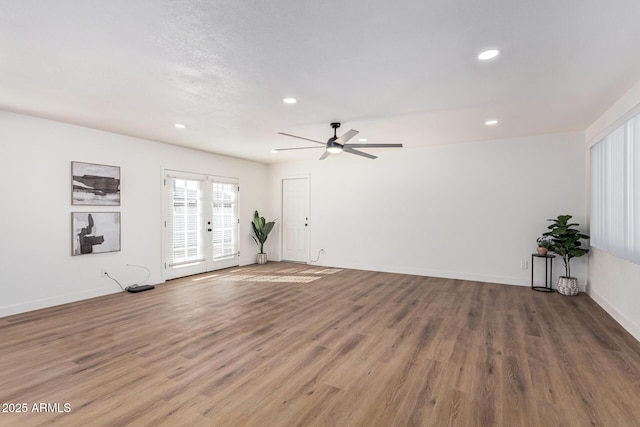 spare room featuring french doors, ceiling fan, and hardwood / wood-style floors