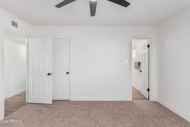 unfurnished bedroom with light carpet, a closet, and ceiling fan