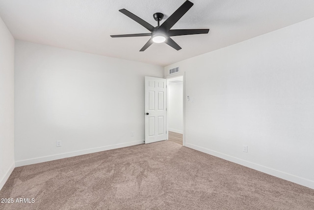 unfurnished room featuring ceiling fan and carpet