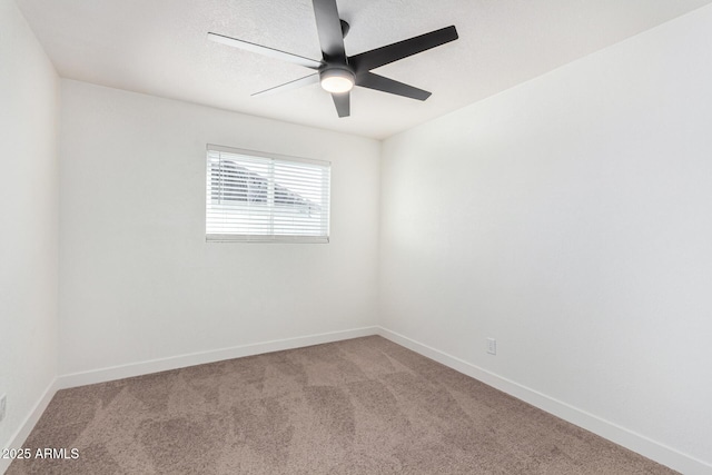 empty room featuring carpet flooring and ceiling fan