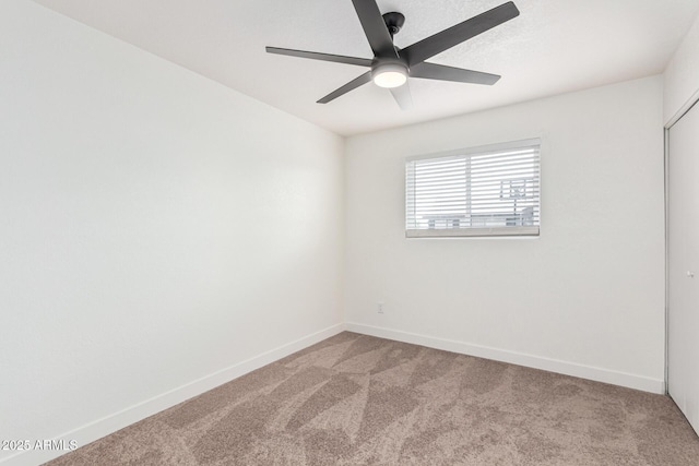 carpeted empty room with ceiling fan