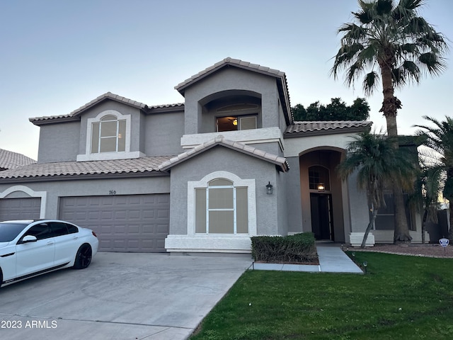 mediterranean / spanish house featuring a front yard and a garage