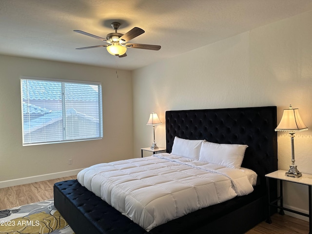 bedroom featuring wood-type flooring and ceiling fan