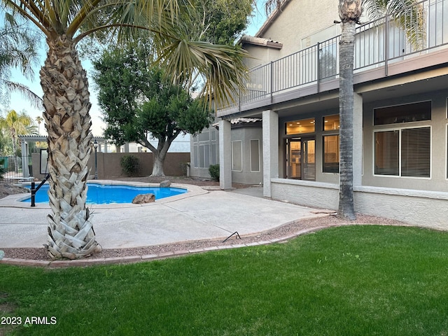 view of pool featuring a yard and a patio