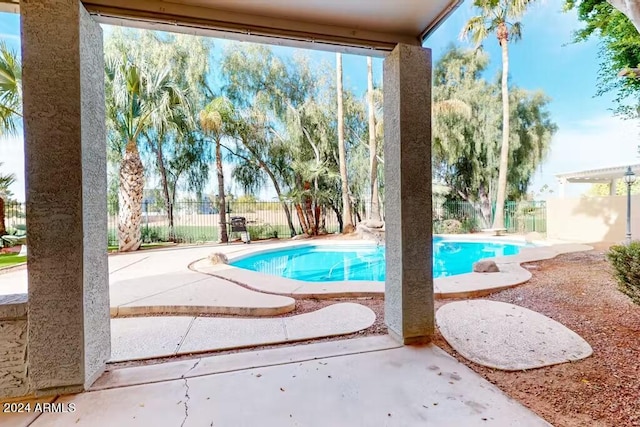 view of swimming pool featuring a patio area