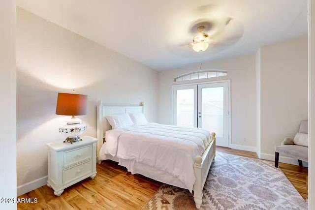 bedroom with ceiling fan, light wood-type flooring, and access to exterior