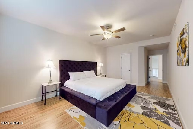 bedroom with wood-type flooring and ceiling fan