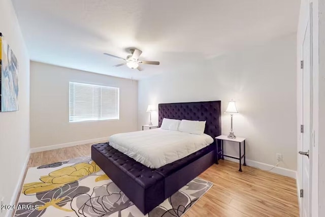 bedroom with ceiling fan and light hardwood / wood-style flooring