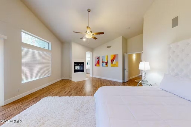 bedroom with vaulted ceiling, light wood-type flooring, and ceiling fan