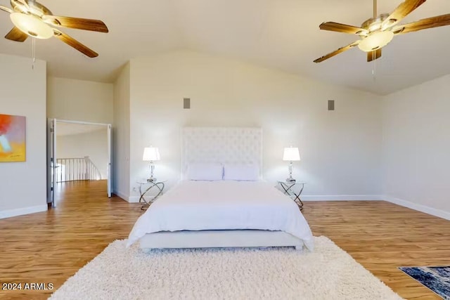 bedroom featuring hardwood / wood-style flooring, vaulted ceiling, and ceiling fan