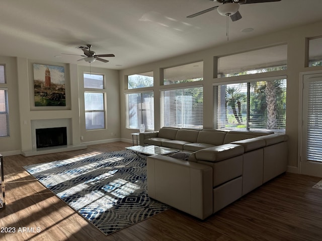 living room featuring dark hardwood / wood-style floors and ceiling fan