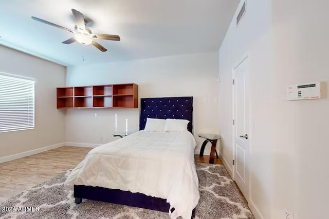 bedroom with ceiling fan and light hardwood / wood-style floors