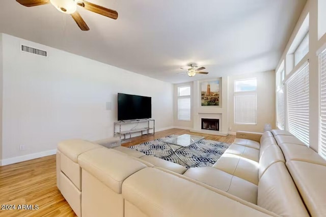 living room featuring light wood-type flooring and ceiling fan