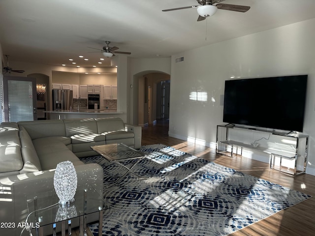 living room with hardwood / wood-style floors and ceiling fan