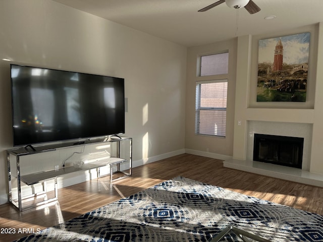 living room featuring ceiling fan and hardwood / wood-style flooring