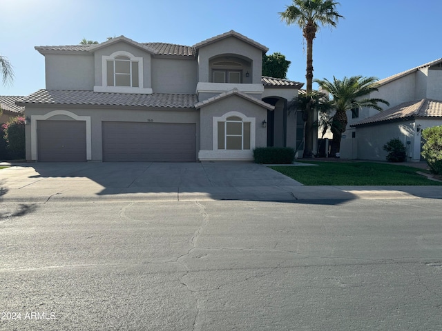 mediterranean / spanish home with a garage