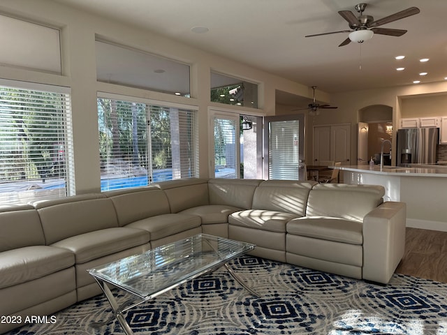 living room with hardwood / wood-style floors and ceiling fan