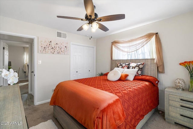 carpeted bedroom featuring a closet and ceiling fan