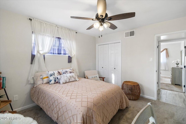 bedroom featuring light colored carpet, a closet, and ceiling fan