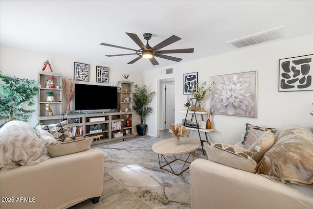 living room featuring ceiling fan and light hardwood / wood-style floors