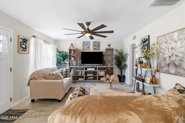 living room with ceiling fan and light hardwood / wood-style floors