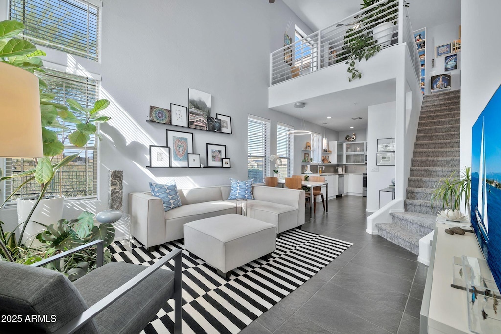 tiled living room featuring a high ceiling